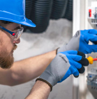 A skilled Wired Electric technician installing a state-of-the-art electrical panel in O'Fallon, MO.